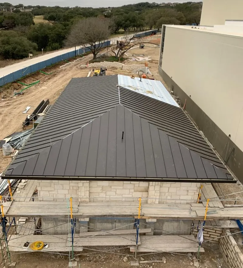 Metal roof new construction with scaffolding in Freeport